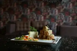 A delectable gourmet dish featuring roasted meat and colorful vegetables beautifully presented.