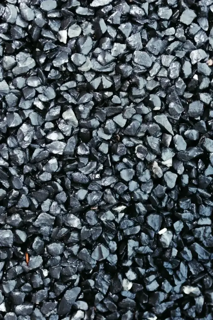 Detailed close-up image of a textured black gravel surface, ideal for backgrounds.