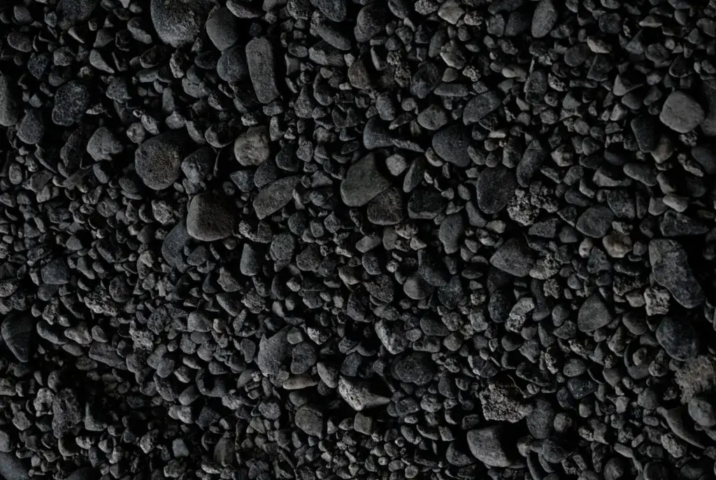 Close-up view of dark pebbles creating a natural textured background.